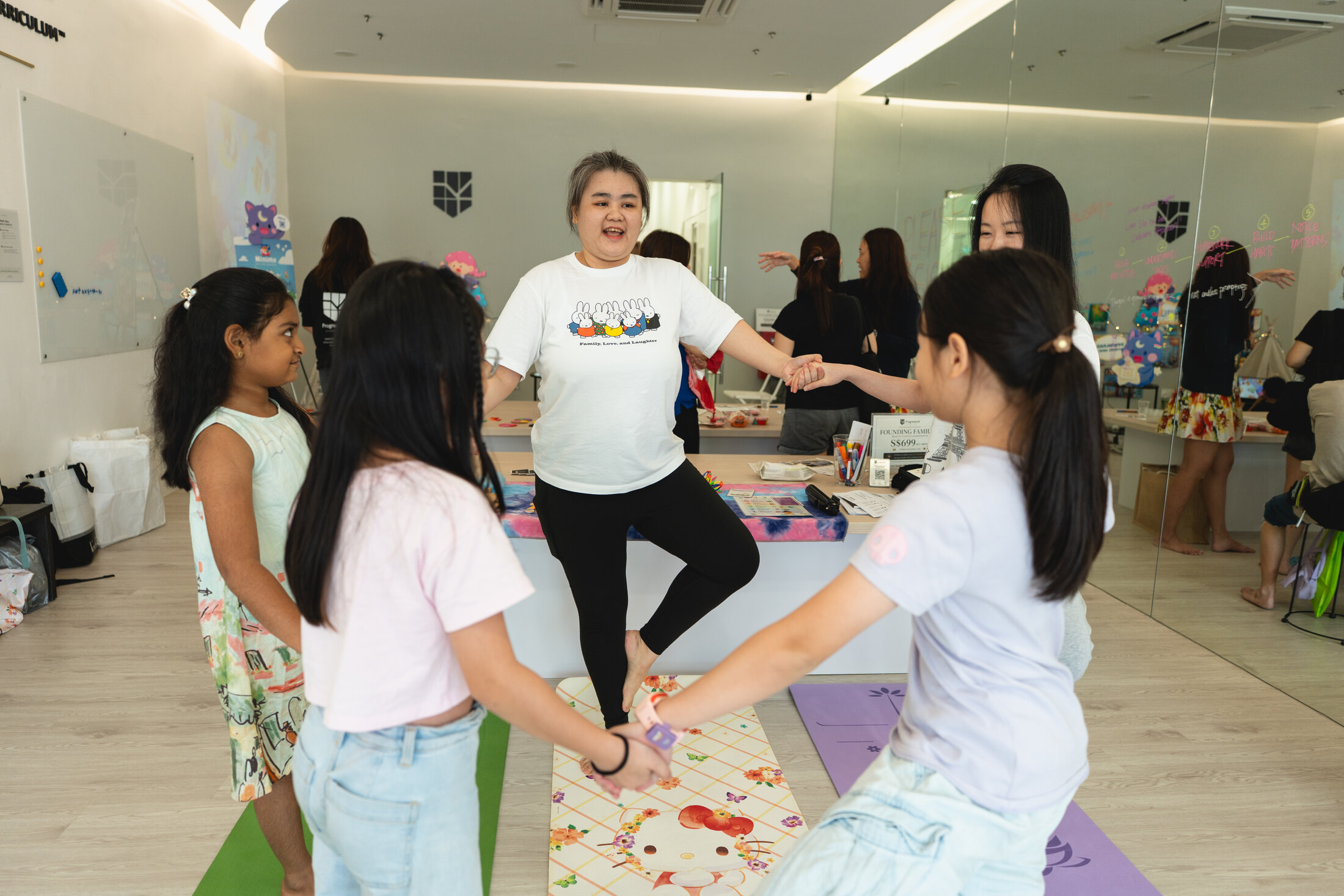 Children participating in a guided yoga experience at ProgressLab