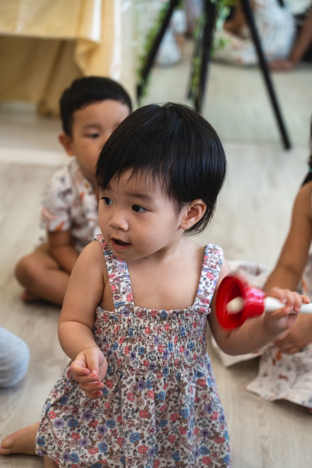 A young child exploring a handbell at ProgressLab’s open house