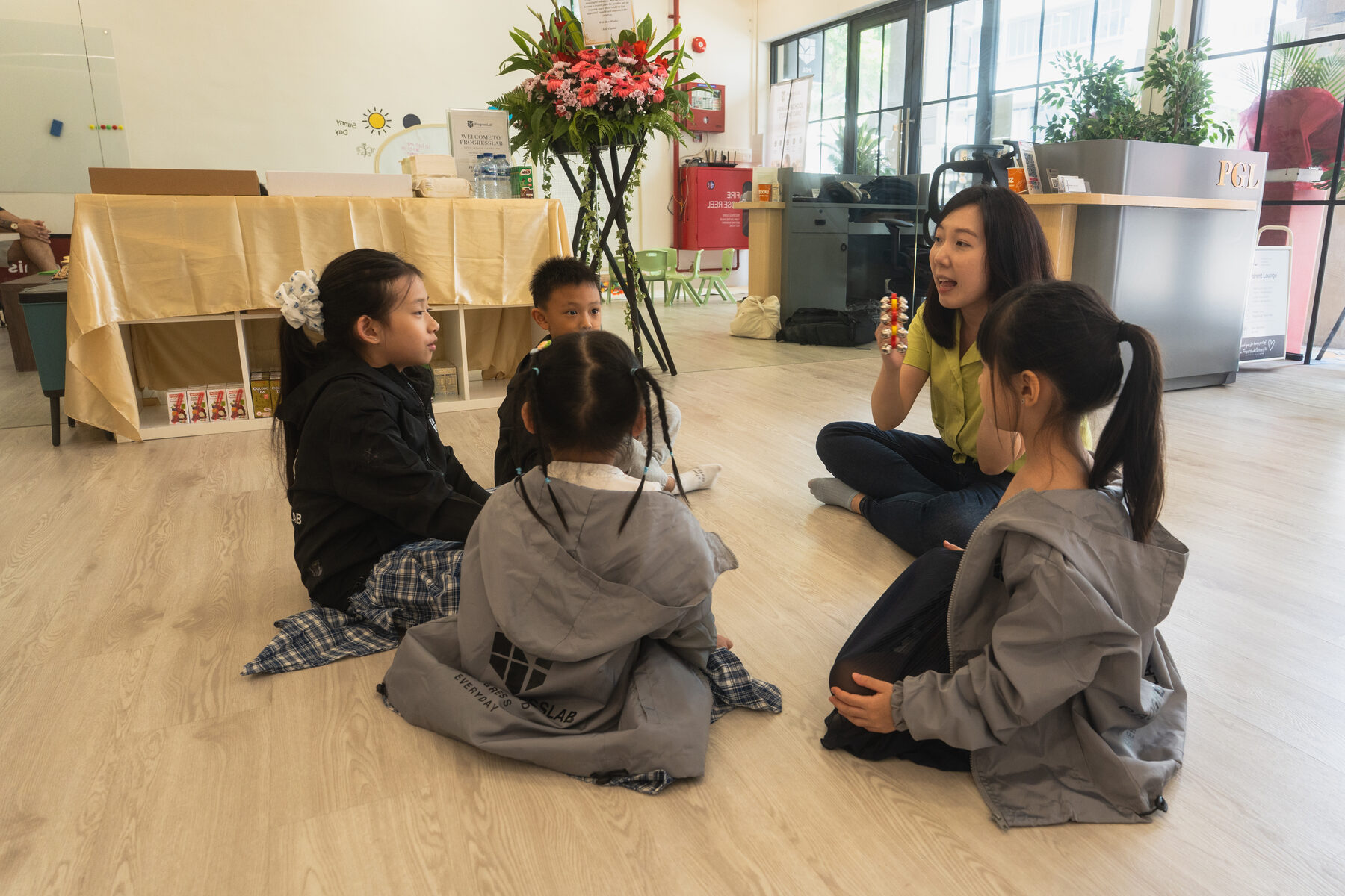 Educator sitting with children in the ProgressLab centre