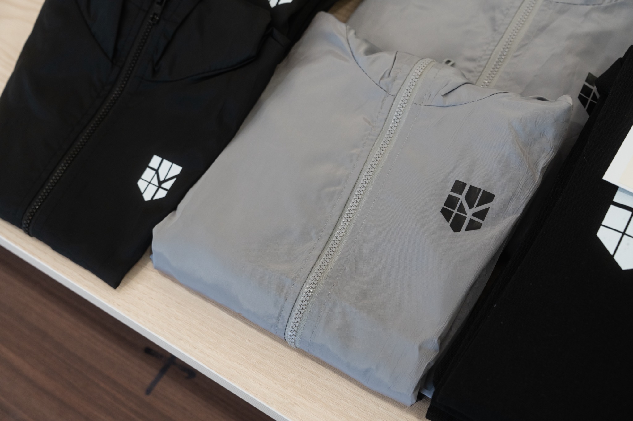 Grey and black ProgressLab windbreakers