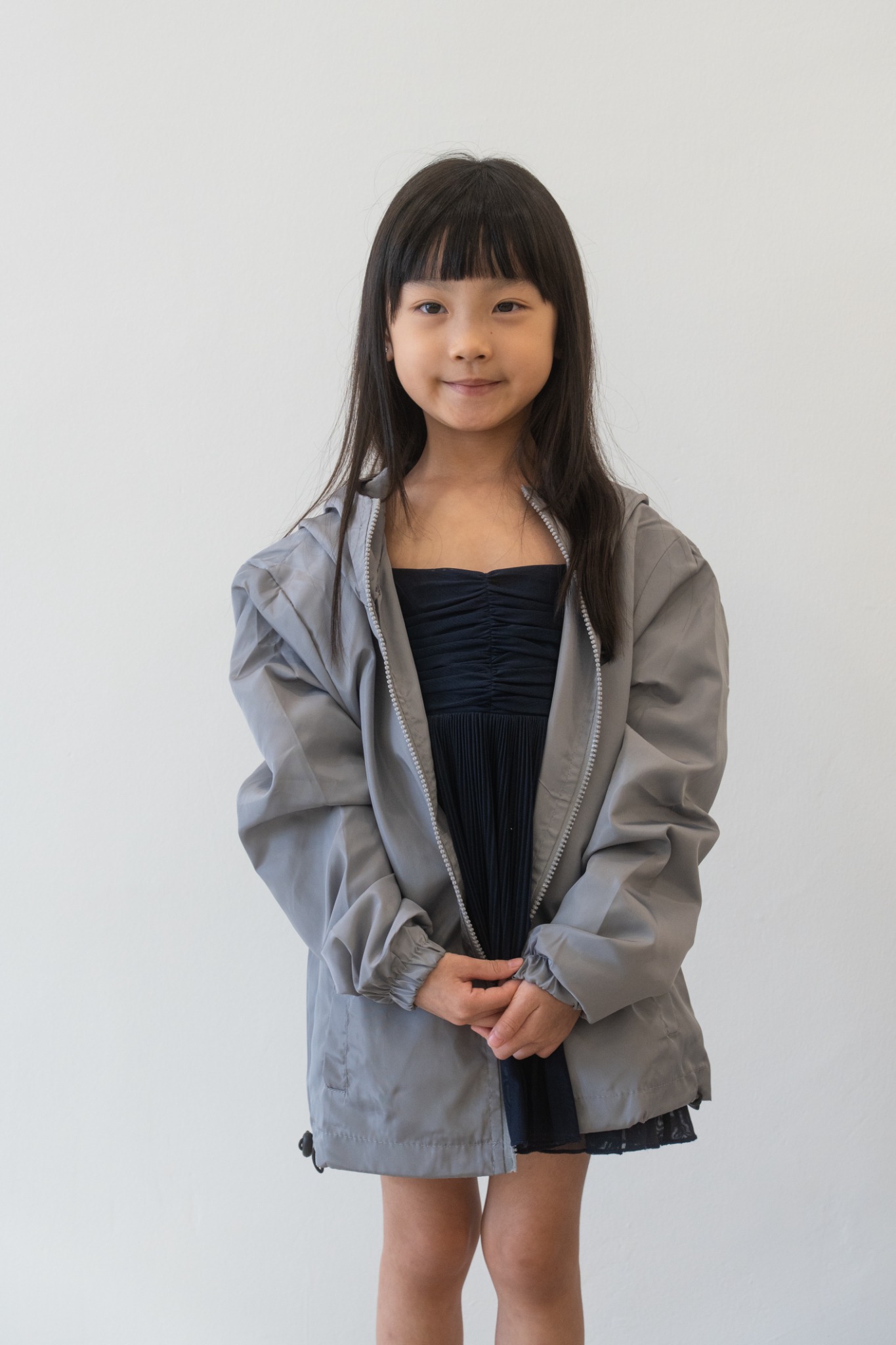 Child wearing the grey ProgressLab windbreaker from the front